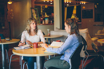 Women having Bible study in a restaurant.