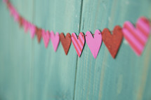 heart banner on a teal wall 
