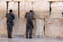 Israeli Jewish soldiers worshiping at the Western Wall in Jerusalem.