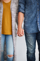 couple standing holding hands 