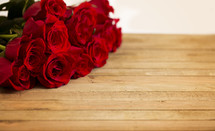 red roses on wood background 