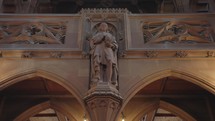 The Gothic-themed statues of notable figures inside the John Rylands Research Institute and Library in Manchester, UK.