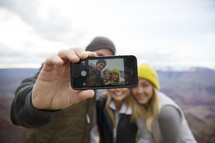 friends taking a selfie on a mountaintop 