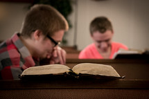 open Bibles and conversation in church pews