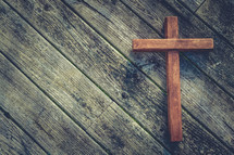 wooden cross on wood background 