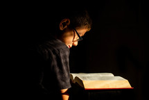child reading a Bible 