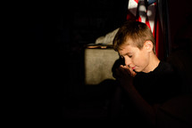 child praying near an American flag 
