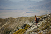 a woman hiking on a mountain landscape 