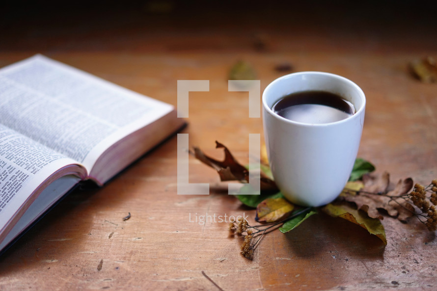 fall leaves, open Bible and mug of hot tea 