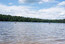 people swimming in a lake in summer 