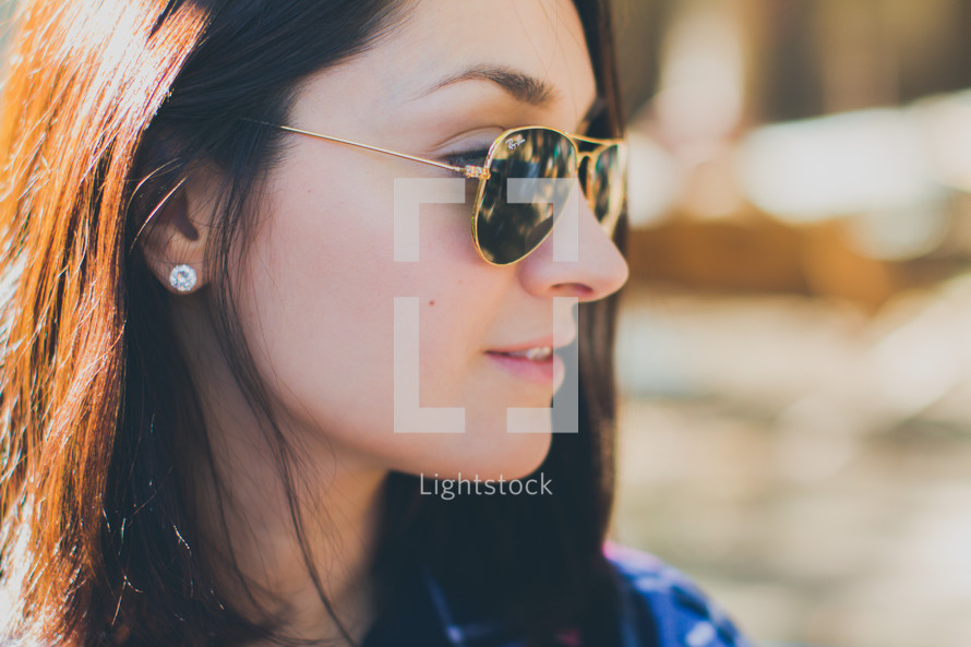 head shot of a woman in sunglasses 
