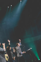 musicians singing with raised hands at a worship service 