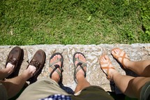 men's feet in loafers and sandals 