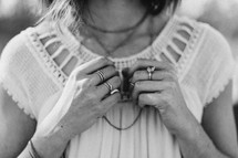 a woman fidgeting with her jewelry 