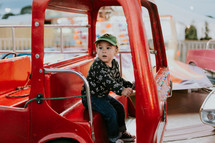 A boy on a ride at the fair 