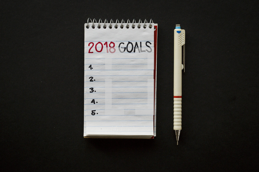 pen and 2018 goals on a notepad 