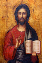 Painting of Jesus holding an open book.