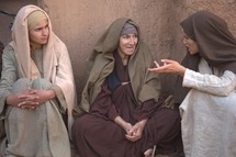 women talking in a village in biblical times 