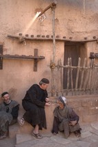 men talking in a village in biblical times 