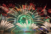 fireworks over a ferris wheel at an amusement park