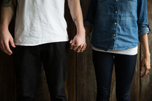 a couple standing holding hands.