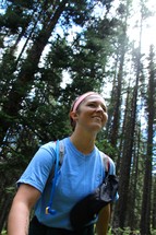 a young woman hiking in a forest 