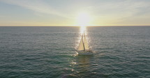 Flying around sailboat in the ocean. Sailboat on ocean bay aerial. Summer sea cruise on ship. 