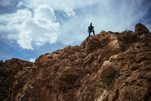 A man standing on top of a cliff.