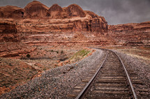 train trains through a red rock canyon 