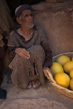 a poor man in biblical times sitting at a market 