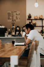 man reading a Bible in a coffee shop 