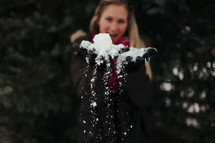 a woman holding snow 