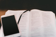 iPhone on the pages of a Bible 