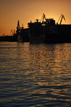 ships at a port harbor at sunset 