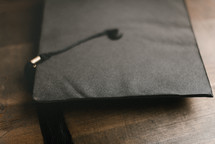 graduation cap on a wood background 