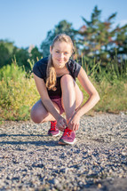 jogger tying her shoes 