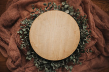 boxwood leaves around a wood circle 