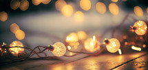 String of glowing christmas lights on a wood floor. Digital art image.