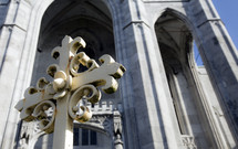 cross in front of a cathedral
