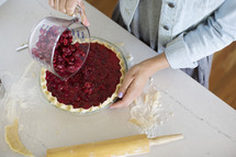 Woman making a home made cherry pie.
