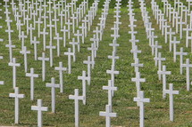 simple cross grave markers in a military grave yard 
