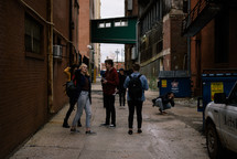 crowd of people standing in an alley 