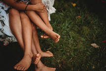 bare feet of siblings in summer 