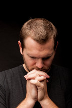 a man with head bowed in prayer