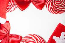 Flatlay of some red Christmas decoration, on a white background. Background for Christmas.