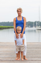 mother and son standing together on a dock 