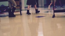 elementary school students walking to class in a school hallway 