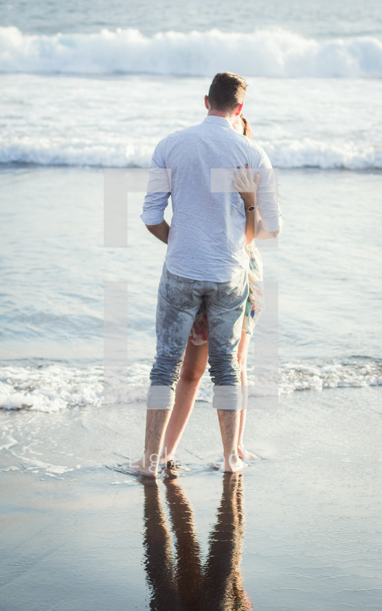 a couple hugging on a beach