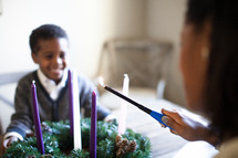 mother and son lighting an Advent wreath 