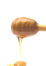 Honey with a Honeycomb Spoon on a White Background